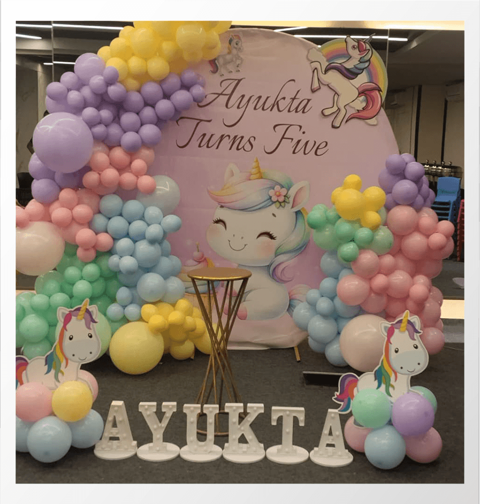 Kids birthday decoration with balloons and cake setup 10